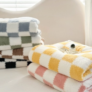 Soft checkered flannel throw blankets in assorted colors stacked for cozy home decor