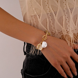 Gold chain bracelet with irregular pearls and seashell pendant featuring OT toggle clasp