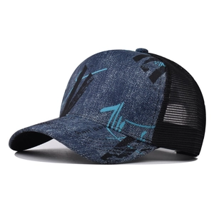 Detail showing gradient floral embroidery and dark blue denim texture on baseball cap