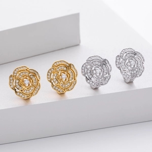 Close-up of S925 silver camellia flower earrings with gold and silver finishes