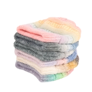 Colorful gradient knit beanies stacked vertically in pink, purple, and rainbow shades