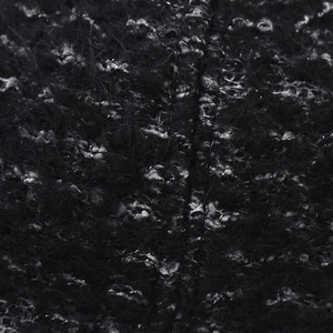 Macro shot of fluffy black and white tweed knit fabric texture with wool fibers