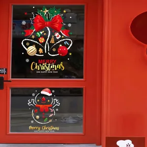 Close-up of Christmas window decals featuring snowman, bells and Merry Christmas text