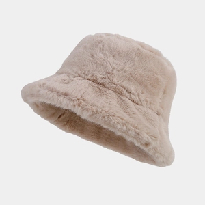 Detailed macro view of soft beige plush faux fur texture on a winter bucket hat