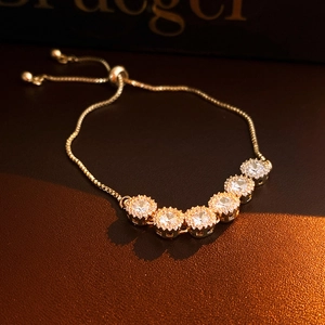 Macro shot of gold-plated bracelet featuring six round clusters of sparkling cubic zirconia
