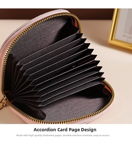 Detail view of pink shell-shaped accordion card holder with golden zipper and multi-slots