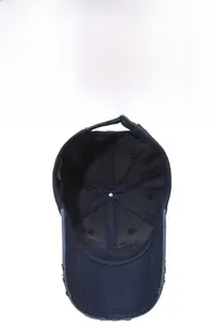 Detail of vintage washed baseball cap featuring frayed brim edges and metal adjustment buckle