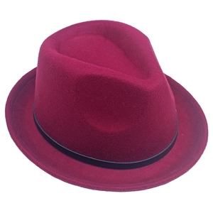 Close-up of a classic burgundy wool felt fedora hat with a stylish black decorative ribbon