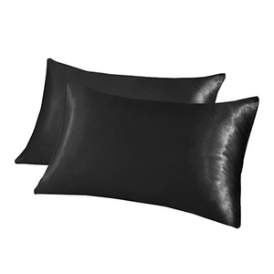 Detail shot of black satin silk pillowcases showing smooth texture and soft sheen