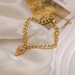 Detailed view of leopard head gold chain bracelet with green zircon eyes and crystal pavé