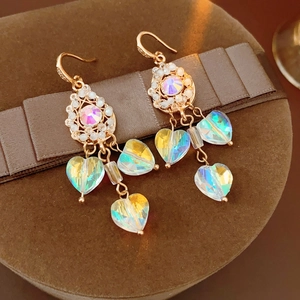 Detailed close-up of vintage heart tassel earrings with colorful iridescent crystals