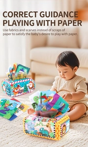 Detail of colorful fabric tissue box toy with cartoon prints for infant sensory play