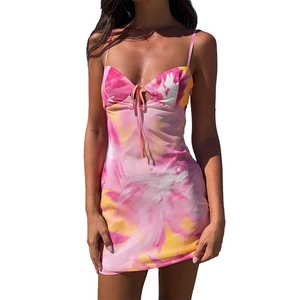 Detail view of tie-dye mini dress featuring thin straps and front lace-up cutout detail