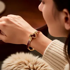 18k gold plated bangle featuring a red bear pendant and Greek key pattern on the band