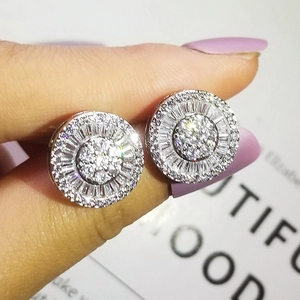 Macro shot of silver stud earrings with pave-set round and baguette-cut cubic zirconia