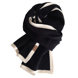 Minimalist black knit scarf with cream contrast trim and premium leather patch logo