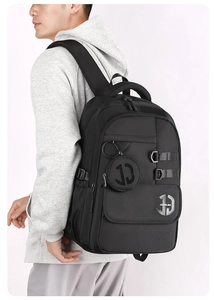 Detailed back view of a minimalist large capacity black backpack with small hanging pouch