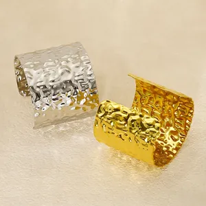 Minimalist wide open cuff bracelet in gold and silver finish with hammered metal texture