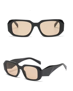 Detail view of thick black geometric sunglasses with brown lenses and faceted temples