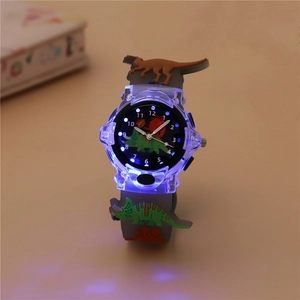 Close-up of kids dinosaur watch with blue LED glowing light and gray silicone strap