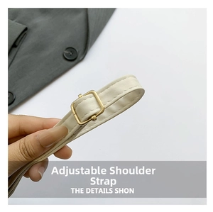 Detail of off-white faux leather adjustable shoulder strap with gold metal buckle