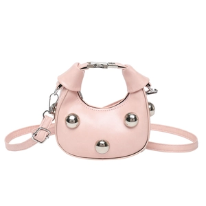 Pink crescent crossbody handbag with large silver stud rivets and a modern design