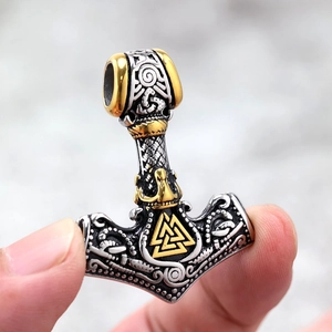 Nordic Mjolnir pendant in silver and gold stainless steel with intricate Valknut relief
