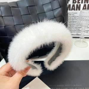 Close-up of fluffy white mink fur headband showing soft texture and premium quality