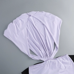 Detail of light purple and black dress featuring back hollow out design and neck button