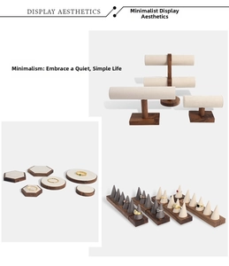 Detail view of walnut wood jewelry display set with beige velvet pads for rings and necklaces