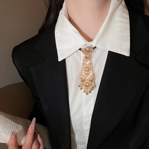 Detailed close-up of a vintage gold bolo tie necklace with yellow crystals and tassels