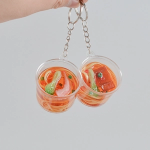 Realistic mini ramen beef noodle keychain with green vegetables and meat in a transparent bucket