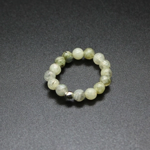 Detail of 4mm grey-green natural stone beads and silver metal bead on an elastic ring