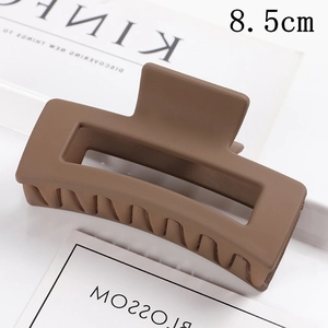 Matte brown rectangular hair claw clip detail shot showing stylish daily hair accessory.