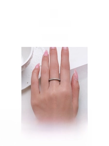 Macro detail of minimalist S925 sterling silver band ring with full pavé diamonds