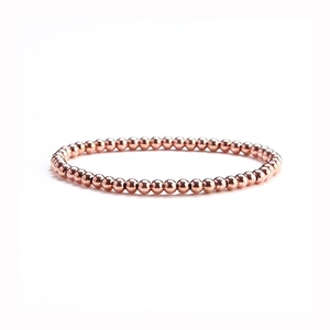 Detail shot of rose gold beaded bracelet with high-polish finish on stainless steel beads