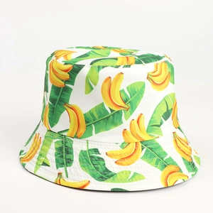 Detailed close-up of white bucket hat with banana and tropical leaf print pattern
