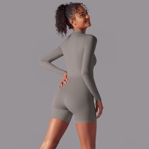 Back view of gray long sleeve one-piece romper showing high-stretch athletic fit