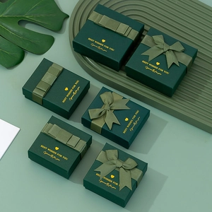 Green textured jewelry gift boxes with silk ribbons and golden Best Wishes engraving