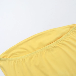 Detail shot of bright yellow plain weave fabric texture and stitching on the crop top