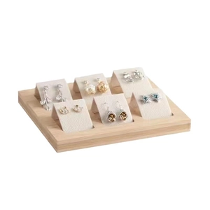 Bamboo wood 36-slot jewelry display tray with white studs stands on a wooden base