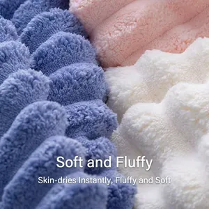 Thick coral fleece towels in blue, pink, and white with soft wavy pile texture