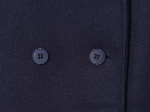 Detailed macro view of dark navy wool fabric and classic double-breasted buttons