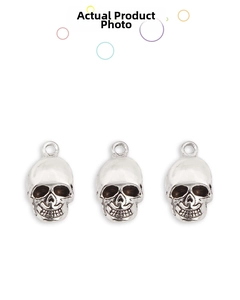 Detailed close-up of three vintage silver alloy skull pendants for DIY jewelry crafting