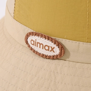 Detail shot of color-block kids bucket hat with aimax embroidered logo patch