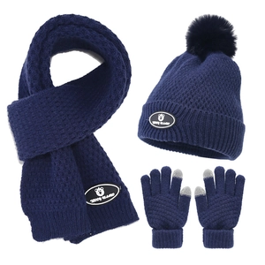 Detail of dark blue winter knit set featuring touchscreen gloves and teddy logo patch