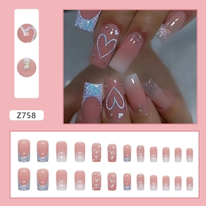 French tip press-on nails with white gradient, glitter hearts, and rhinestone accents