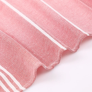 Macro shot of red and white striped Turkish cotton beach towel showing soft texture