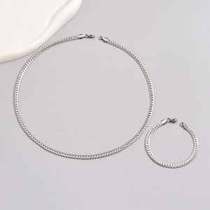 Polished stainless steel snake chain necklace and bracelet set for men on gray background