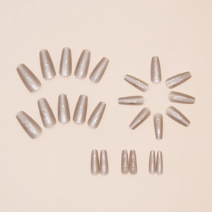 Detailed set of cat eye press-on nails with celestial sun and moon motifs in long coffin shape
